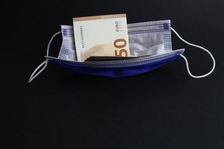 Protective mask with banknotes and black background