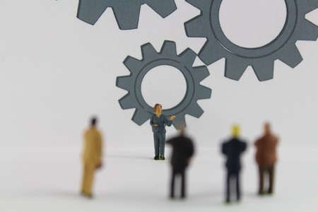 large gears with figures of business people in the foreground stands for innovation and business ideasの写真素材