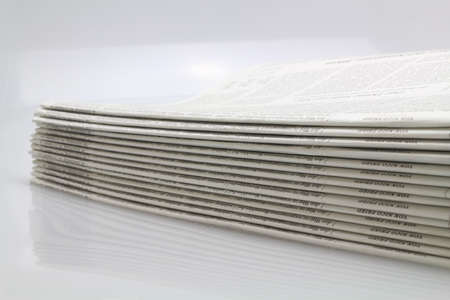 Stack of Newspapers with Isolated White Backgroundの写真素材