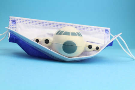 small airplane model with a mask and blue backgroundの写真素材
