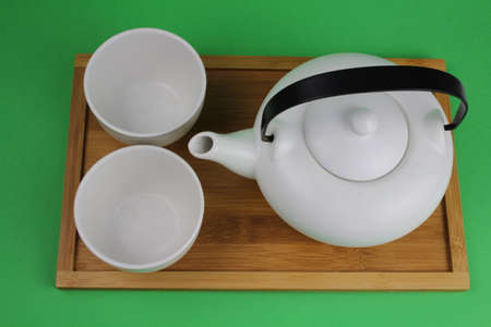 Japanese teapot with small cups and different types of teaの写真素材