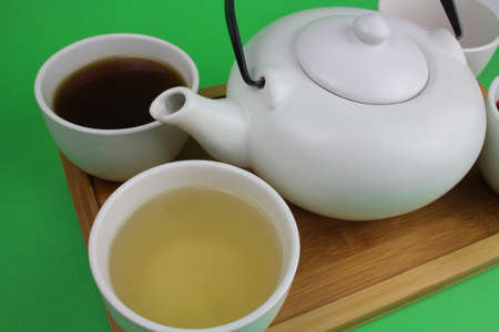 Japanese teapot with small cups and different types of teaの写真素材