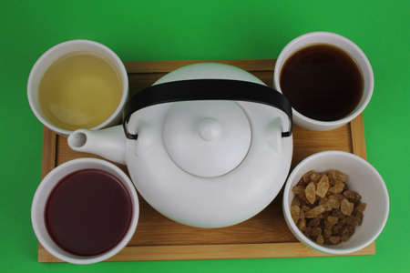 Japanese teapot with small cups and different types of tea