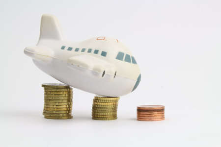 small plane on piles of coinsの写真素材