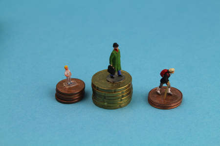 different figures of people stand on euro coinsの写真素材