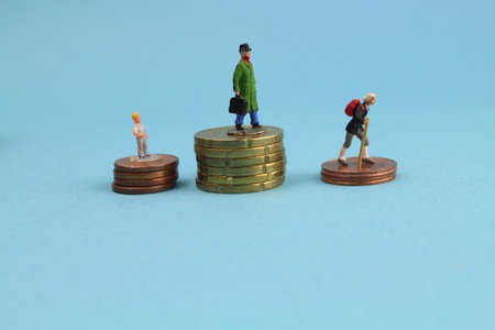 different figures of people stand on euro coins