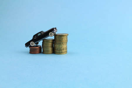 small model car stands on euro coinsの写真素材