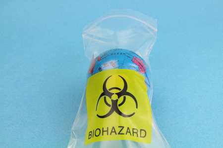 small globe in a plastic bag with the biohazard symbolの写真素材