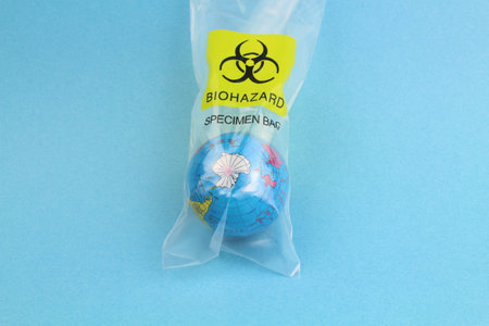 small globe in a plastic bag with the biohazard symbol