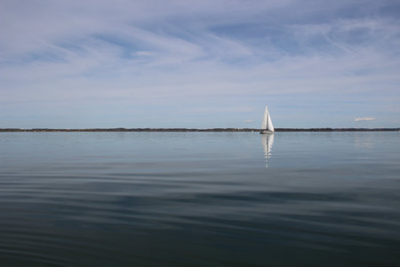 Sailboat on the lake in a sunny day in early springの写真素材