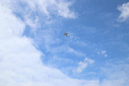 Airplane in the blue sky with clouds, closeup of photoの写真素材