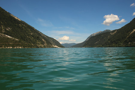 view to a beautiful lake surrounded by mountainsの写真素材