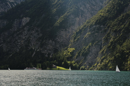 the sun is shining on a part of a lakesideの写真素材
