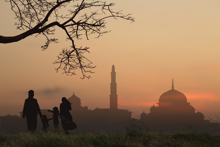 Family Muslims  pray for God  in Ramadan with hope and forgiveness of the background the mosqueの写真素材