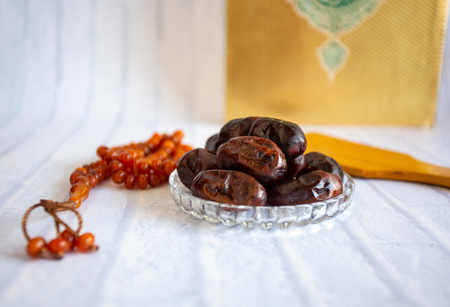 fthar Food evening meal for Ramadan kareem,Concept: Date of Islamic fasting,fruit date placed on a white background rosaryの写真素材