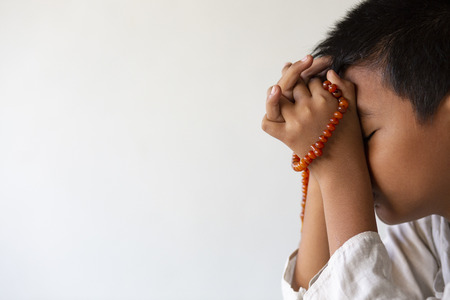 Muslims young  pray for God  in Ramadan with hope and forgiveness,Islam is a belief for the five-day prayer,Concept: Culture beliefs for mercy from heavenの写真素材