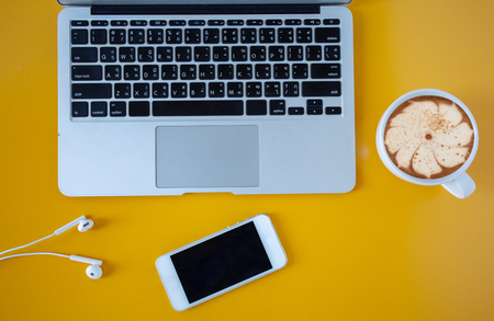flat lay Notebook placed on a color table with a cup of coffee,office desk table with laptop and supplies,Top view with copy space,Concept:space to create ideas for successの写真素材