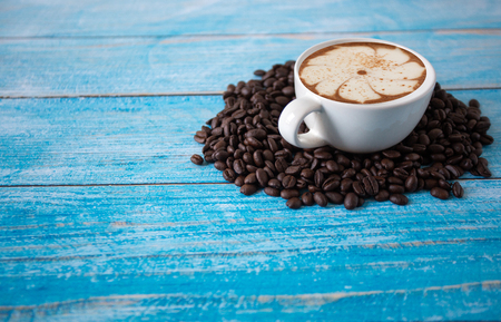 roasted coffee beans placed on an old blue wooden floor,top view coffee cup for background,Concept:ingredient mocha breakfast drink food freshの写真素材