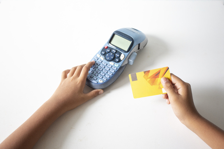 Holding a credit card and entering the security code using a laptop,online  payments app smartphone in coffee shop,concept :Business banking transactions with 5G technology through internet dataの写真素材