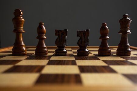 Chess placed on a wooden table,concept : of business strategy and tactic battle,symbol competition game success play victory warの写真素材