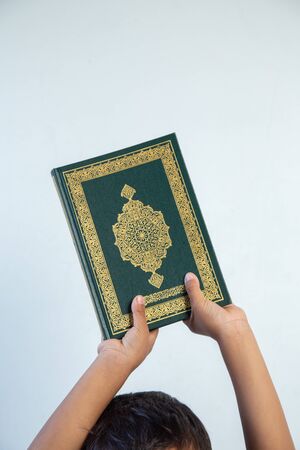 Quran - holy book of Muslims religion, Concept: open book holy prayers for god,Friday In the month of Ramadan  religion Islamic worshiping faith and learn koran and rosary put on wooden  boardsの写真素材