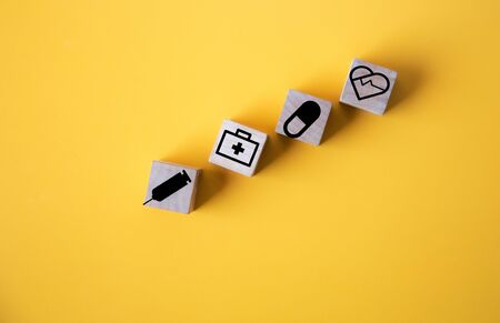 wood cube with a medical symbol  angle Flat lay,Concept: Health insurance family covid-2019...