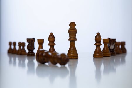 Chess placed on a wooden table, concept: of business strategy and tactic battle, symbol competition game success play victory war leader, Planning a business teamwork battle strategy for successの写真素材