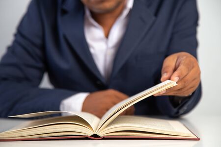 Businessman reading  a book on a desk in the office,Concept: Business education to succeed that...
