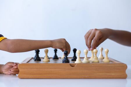 Chess is in the hands of children,Abstract Sports games are the strategy of victory for the leader,Concept: Planning a business teamwork battle strategy for successの写真素材