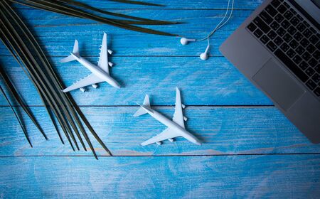 Flat lay traveler accessories plane and passport  on blue background  design copy space for text,の写真素材