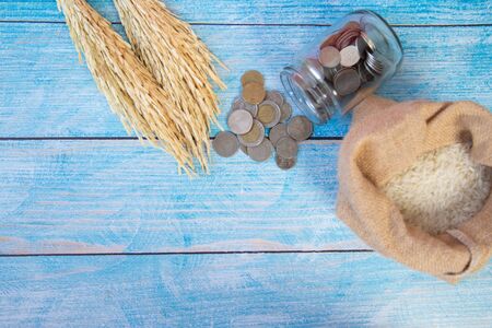 ZAKAT donation for Muslim according to religious principles during the Ramadan month, concept: rice grain in bow and rosary on woodの写真素材