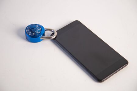abstract  digital devices detox, Smartphone  unlock metal security lock key on wooden table,
Concept: hacker Password for data technology digital crime financeの写真素材