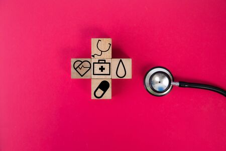 wood cube with a medical symbol  angle Flat lay,Concept: Health insurance family covid-2019 epidemic,management protect healthcare to a virus,care service doctor treatment for hospitalの写真素材
