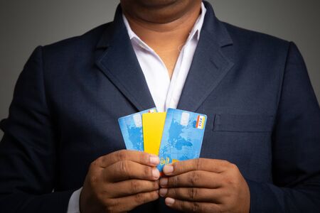 Asian Businessman holding a credit card for shopping online 
,concept: Business e-Commerce banking ordering transactions for technology, online payments app entering the security in a shopの写真素材