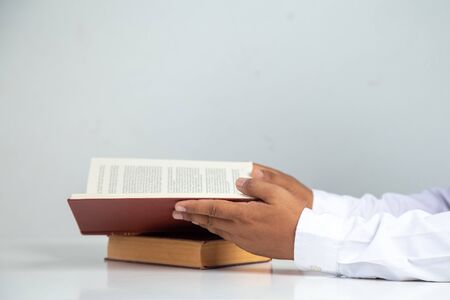 Businessman reading  a book on a desk in the office,Concept: Business education to succeed that challenges teamwork,
 young student studying  literature  classic in the  room collegeの写真素材