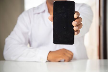 businessman working with smartphone modern devices communication technology for payments online,
Concept: work at home, abstract digital devices detox
 entrepreneur connection success professionalの写真素材