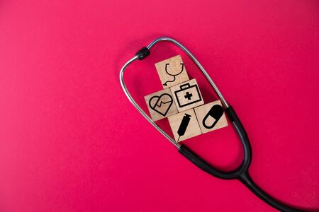 wood cube with a medical symbol  angle Flat lay,Concept: Health insurance family covid-2019 epidemic,
management protect healthcare to a virus,care service doctor treatment for hospitalの写真素材