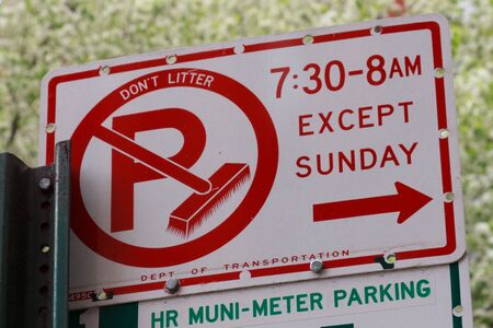 Cleaning the street parking sign in New Yorkの写真素材