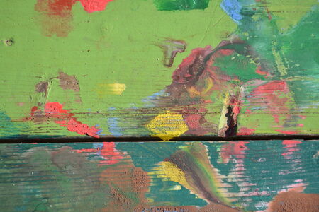 Colorful design painted on chipped and cracked woodの写真素材