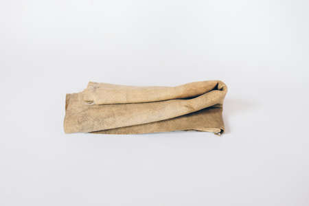 Dirty rags or chamois in a box isolated in white background. Kanebo or Chamois texture