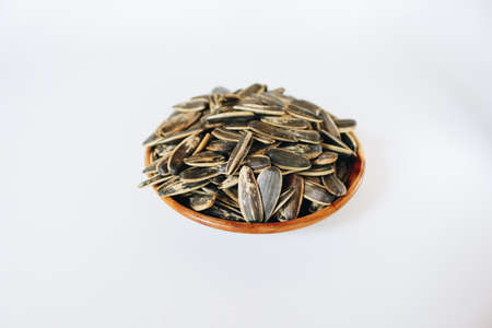 Bowl of Sunflower seeds isolated on white background.の写真素材