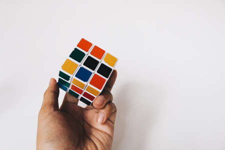 Yogyakarta, Indonesia - November, 2019: Rubik's cube toy 3x3 isolated on the white background. Solving difficult tasks.のeditorial素材