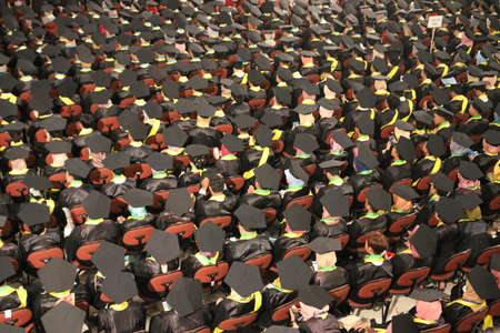 Top view of group of university graduates in black gowns lines up for degree in university graduation ceremony. Yogyakarta, Indonesia - December 2019.のeditorial素材