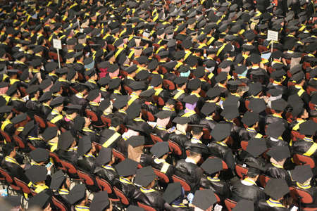 Top view of group of university graduates in black gowns lines up for degree in university graduation ceremony. Yogyakarta, Indonesia - December 2019.のeditorial素材