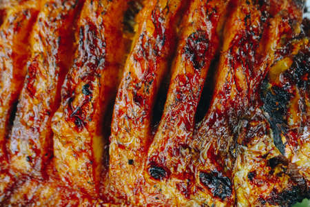 Delicious grilled tilapia (nila bakar) from indonesia with rice, tempeh, vegetables, and chilli sauce in plateの写真素材