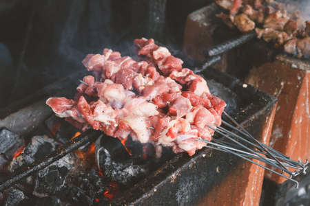 Sate Klatak grilling on charcoal grill. Sate klathak is a unique goat satay or mutton satay dish,...