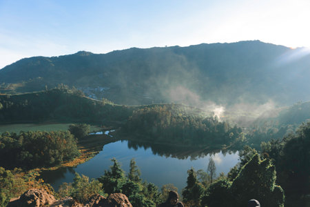 Morning view of Telaga Warna Lake with mountain background at Dieng Plateau, Central Java, Indonesia. Aerial View from Batu Pandang Ratapan Angin Hill.の写真素材