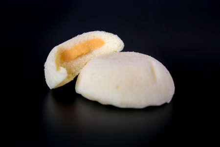 Bakpia Kukus Cake or Steamed Bakpia Cake with Cheese Flavour on wooden plate isolated on white...