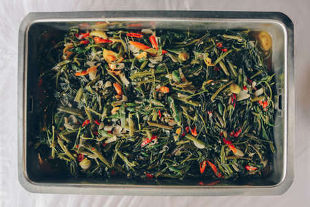 Stir fried water spinach or cah kangkung in steel pan. Asian indonesian food.の写真素材