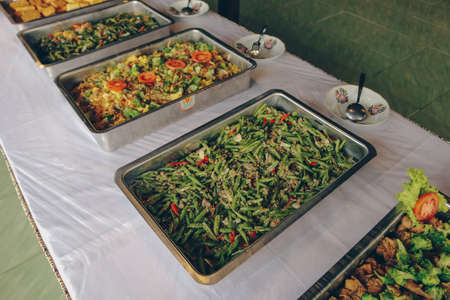 Many dishes on the restaurant such as fried noodles, stir vegetable, chicken yakiniku on the steel...